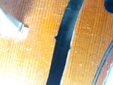 a close up of a violin that is on a table