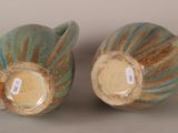 two vases that are sitting next to each other