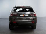 the back end of a grey suv parked in a garage