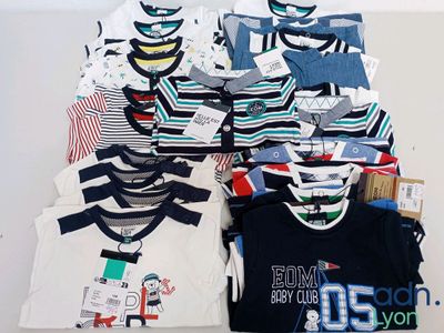a lot of t - shirts that are on a table