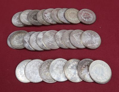 some silver coins on a red cloth with a red background