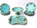 four pieces of blue and green pottery on display