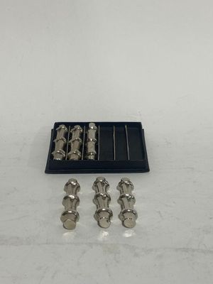 an image of a set of silver metal screws in a black box
