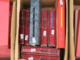 a box full of books with a tie on top of it