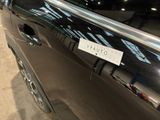 a black car with a sticker on the side of it ' s door