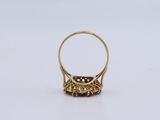 a gold ring with a red stone in the middle