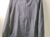 a close up of a jacket hanging on a hanger on a wall