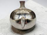 a small silver object sitting on top of a table