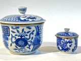 deux vases bleus et blancs posés l'un à côté de l'autre sur une table