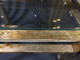 a glass table with a metal frame and a glass top