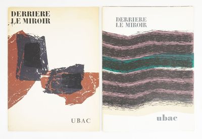 two books on a white surface with a black and green cover
