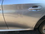 a silver car that is parked on the side of the road