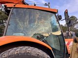 a tractor that is parked on the side of the road