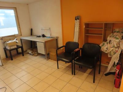 a room with two chairs and a desk in it