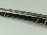 a close up of two swords on a white surface