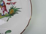 a plate with a painting of a bird on it