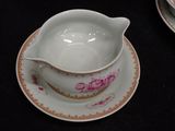 a bowl and saucer sitting on a saucer on a table