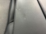 a close up of a car seat with a dirty seat belt