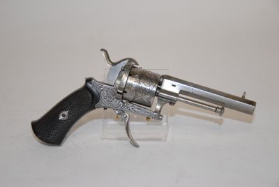 an old revolver with a wooden handle on a white surface