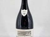 la bouteille de vin rouge est posée sur une surface blanche