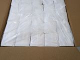 a cardboard box filled with white toilet paper sitting on top of a table