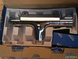 a box with a silver spray gun inside of it