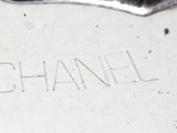 a close up of a silver vase with a heart on it