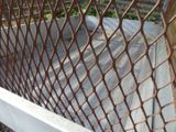 a close up of a metal fence with rust on it