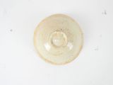 a white bowl with a brown rim on a white surface