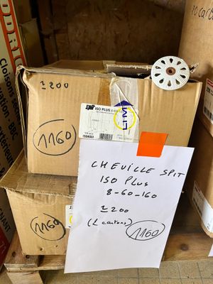 a pile of cardboard boxes with a sign on it