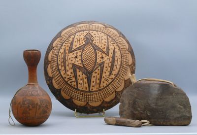 two vases and a bowl sitting on a table