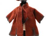 un manteau marron et un chapeau posés sur un mannequin, sur fond blanc