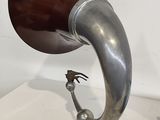 a silver and brown horn shaped object on a white table