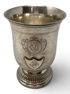 a silver cup that is sitting on a pedestal