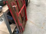 a pile of old tools on a table in a warehouse
