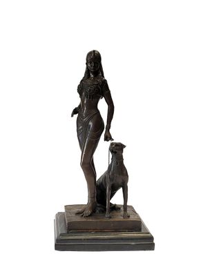 bronze statue of a woman with a dog on a marble base