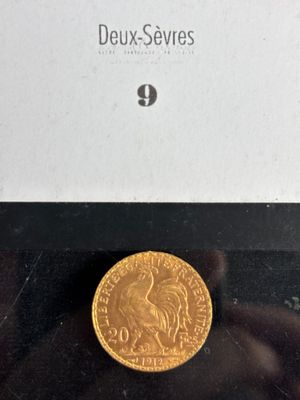 a close up of a gold coin in a box on a table
