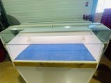 a glass display case in the middle of a room