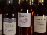 several bottles of wine are lined up on a table