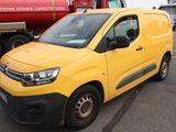 a yellow van that is parked in a parking lot