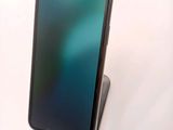 an iphone is sitting on top of a stand on a white surface
