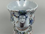a white vase with a picture of a woman on it