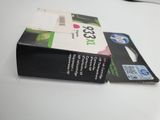 a box of ink sitting on a table next to a keyboard