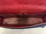 the inside of a red and blue chanel purse