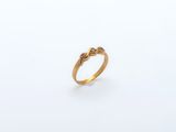 an image of a gold ring with a pink stone in the middle