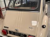 a small beige car parked in a garage