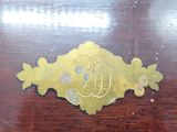 a wooden table with a gold design on it