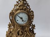 a gold clock on a white background with a white background