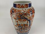 a vase that is sitting on a white surface