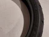 a tire on the floor next to a wall